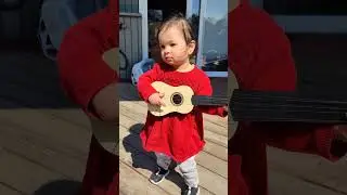 toddler playing guitar