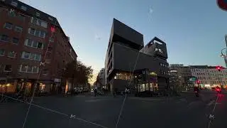Cityscape view of a street corner in Berlin, Germany, at dusk. Modern architecture stands against
