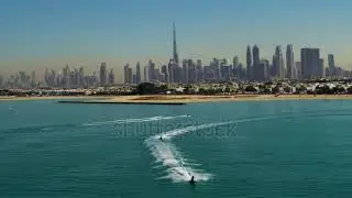 Aerial view of Dubai skyline at sunset with yacht and motor boat, Dubai, United Arab
