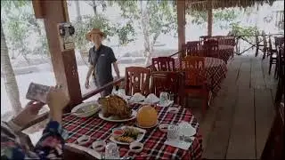 Tourists Enjoy Riverside Lunch at Local Restaurant in Cu Chi Tunnels & Mekong Delta Tour
