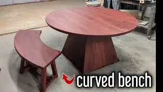 round dining table with a curved base