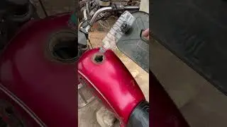 A motorcycle fuel filler made by a genius inventor by recycling used bottles