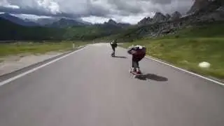 Crazy downhill skateboarders flying by cyclists