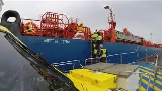 Saybolt surveyor out to sea with tender Callisto Maassluis for sampling cargo tanks m/t Rhonestern