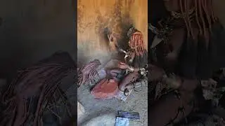 Himba woman uses aromatized smoke to 