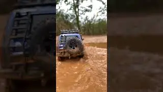 Feeling a bit muddy? 🤔 Our LC80 sure is! Come splash around with us!🚗#rccar #fmsmodel #rcfun #shorts