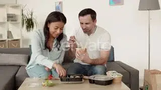 Multiethnic Couple Eating Delivered Food | Stock Footage - Envato elements