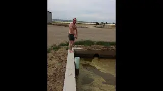 Guy jumps into fresh manure pond.