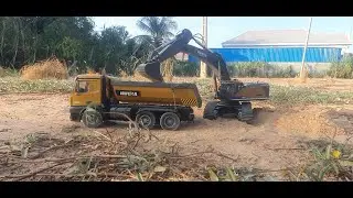 Huina RC Excavator Loading a Dump Truck on a Miniature Construction Site