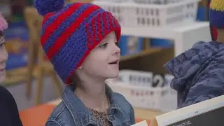Teacher's assistant crochets hats for students