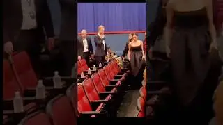Prince Harry and Meghan Markle look tense as they are shown to seats several rows back at premiere