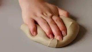 Slowly pressing into a frozen cinnamon roll, icing cracks with soft doughy squishes.