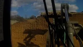 Defacing and raking feed bunks