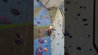 Ryan climbing Trinity's orange shelf.