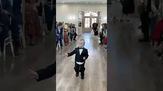 The little tux, the wave, the fist bump 🥹 so cute & so proud #downsyndrome #cutebaby #wedding #cute