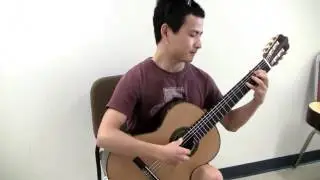 Bin Hu trying a guitar make by Erez Perelman