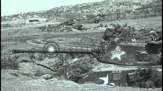 Sherman tank moves and a 57 mm recoil rifle placed overlooking outskirts of Seoul...HD Stock Footage