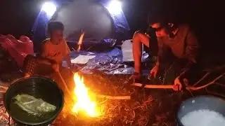 camping fishing and cooking the catch at night
