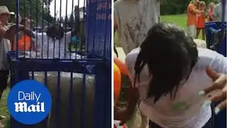Snake Charmer: Woman takes on a snake filled dunking booth - Daily Mail