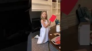 Kenzie opening her First Communion gift from Aunt Katie 3.10.19