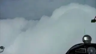 Glider returning from wave soaring flight through cloud