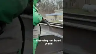 Sandblasting rust off of I beams.