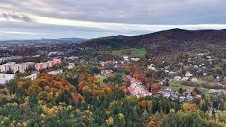 idyllic small town nestled amid rolling mountains with vibrant autumn scenery and winding roads