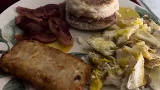 Ham and egg sandwich, bacon, eggs and a hashbrown for breakfast