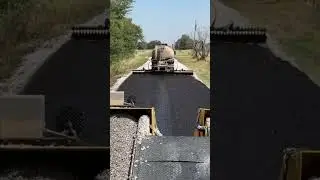 Chip sealing a new road.