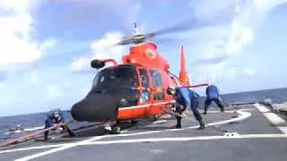 US Coast Guard H-65 Helo lands on USCG Cutter Diligence