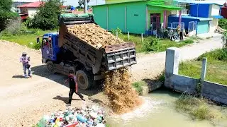 The land flood delete use bulldozer and dump truck push the stone for remove the water