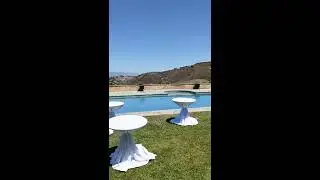 Low top cocktail tables with white skirt table covers by Party Rental Creation