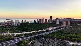 Skyline View Over Tranquil Coast, Peaceful Coastal Scene Featuring Highrises And Natural Landscapes