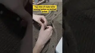 Top view of male tailor sewing button on knitted jacket. #sweater #shorts #shortsfeed