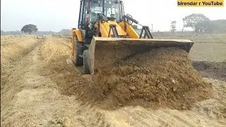 Jcb 3dx backhoe loader driving to work on mud 