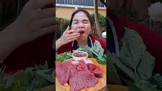 Eating sticky rice with raw, fresh meat and spicy dipping sauce.