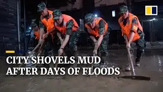 Chinese city works overnight to clear mud-covered roads after days of flooding