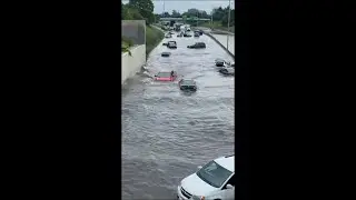 Truck Driving While Submerged in Water That Flood the Road