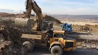 Caterpillar Excavator 385C ME Loading Volvo And Cat Dumper