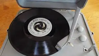 Columbia Portable record player playing am LP record.