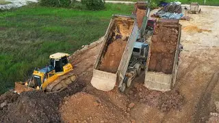 Land Filling New Project And New Site With Dump Truck Pouring Dirt - Bulldozer Working Pushing Dirt