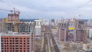 Dolly zoom. Ekaterinburg, Russia. Flight between buildings under construction over the river. New Co