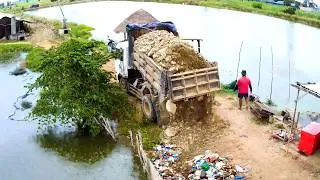 Amazing job and excellent driver use BULLDOZER push stone for fixing the road around the lake