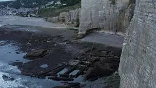 Close Up of Etretat Cliff Arch in France with Ocean View and Sea Gull jumping off Rock