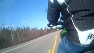 Motor cycle over large metal grate  bridge