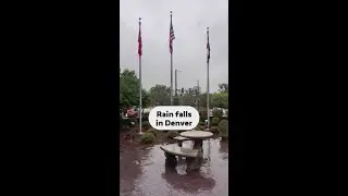 Rain falls in downtown Denver as cold front hits Colorado