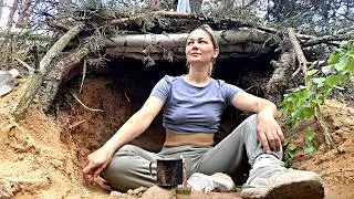 Building a secret hideout in a tree root away from people. Peace and comfort