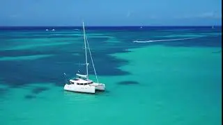 sail boat in beautiful blue ocean water aerial drone
