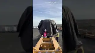 Trucker Tarping the load (windmill Hub)