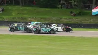 Guy Wilks gives Jānis Baumanis a cheeky nudge on the 1st lap